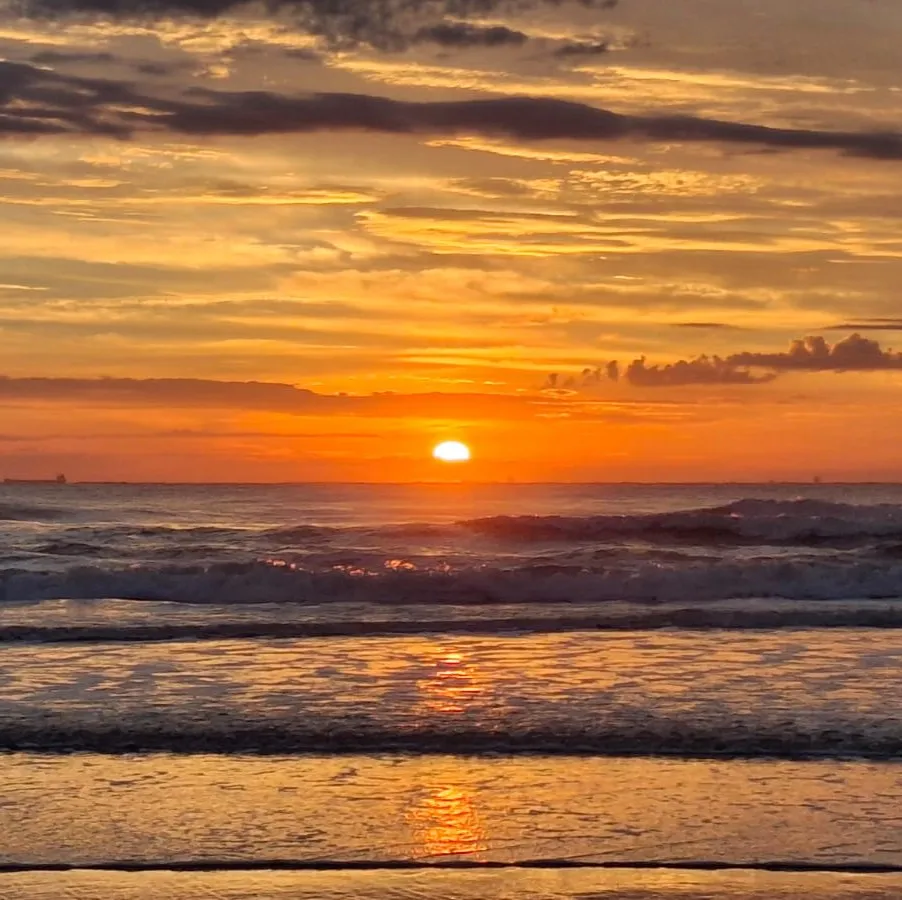 The sun setting over the sea
